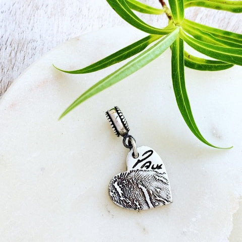 Charm made using an ink print and loved one's own handwriting.